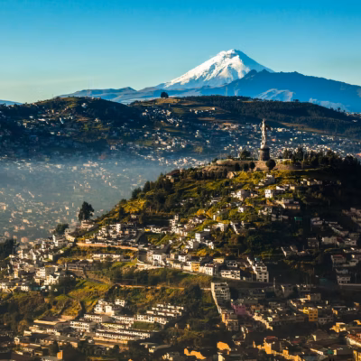 View of El Panecillo in the center of Quito with the Cotopaxi in the background