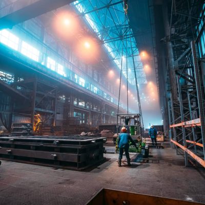 Metallurgical plant or Steel Factory, Large Workshop Interior with industrial cranes and workers, Heavy Industry, Iron and Steelmaking.